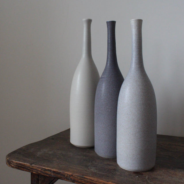 three ceramic bottles in shades of grey by Lucy Burley