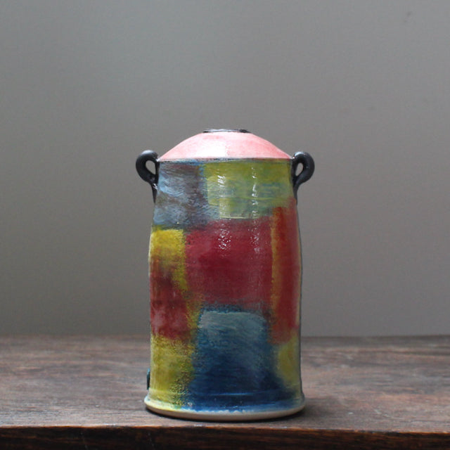 A bright and abstract ceramic vase with a tapered top and small lug handles by John Pollex, leading British ceramicist.