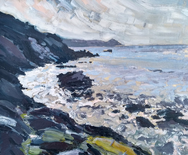 A framed painting of Rame Head in Cornwall by Jill Hudson, called From the Rocks  showing grey sea with dark cliffs with yellow flowers