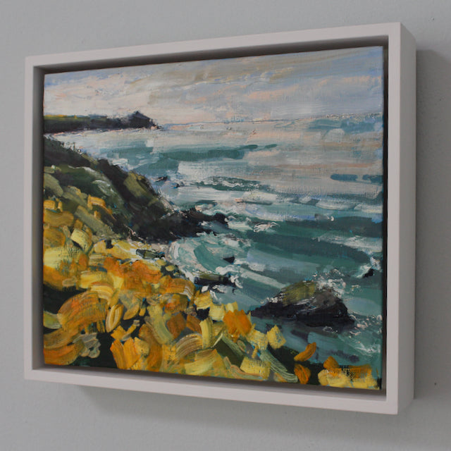 A framed painting of a coastline with yellow flowers, called Wild Yellows it is by UK artist Jill Hudson