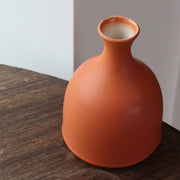 a  Lucy Burley small orange coloured ceramic bud vase.