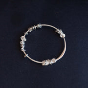 Silver sea siren bangle with silver pieces by Claire Stockings-Baker