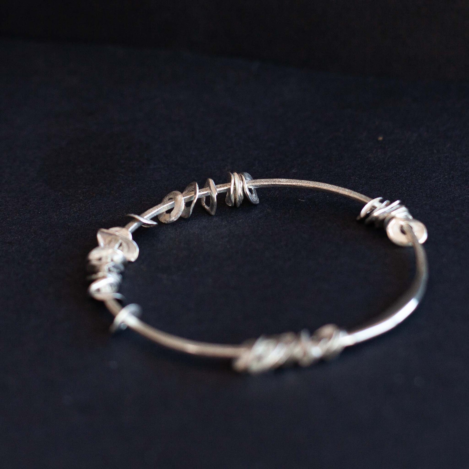 Silver sea siren bangle with silver pieces by Claire Stockings-Baker
