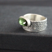 Carin Lindberg - Green tourmaline ring in textured sterling silver close up 2 on raised display box