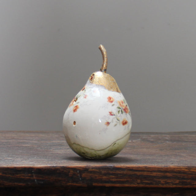large ceramic white pear with orange floral detail and a gold stalk by Remon Jephcott.