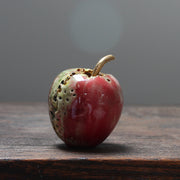 red ceramic apple with  a gold stalk by  Remon Jephcott