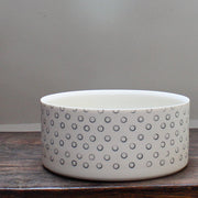 a dish decorated with dark blue small circles.