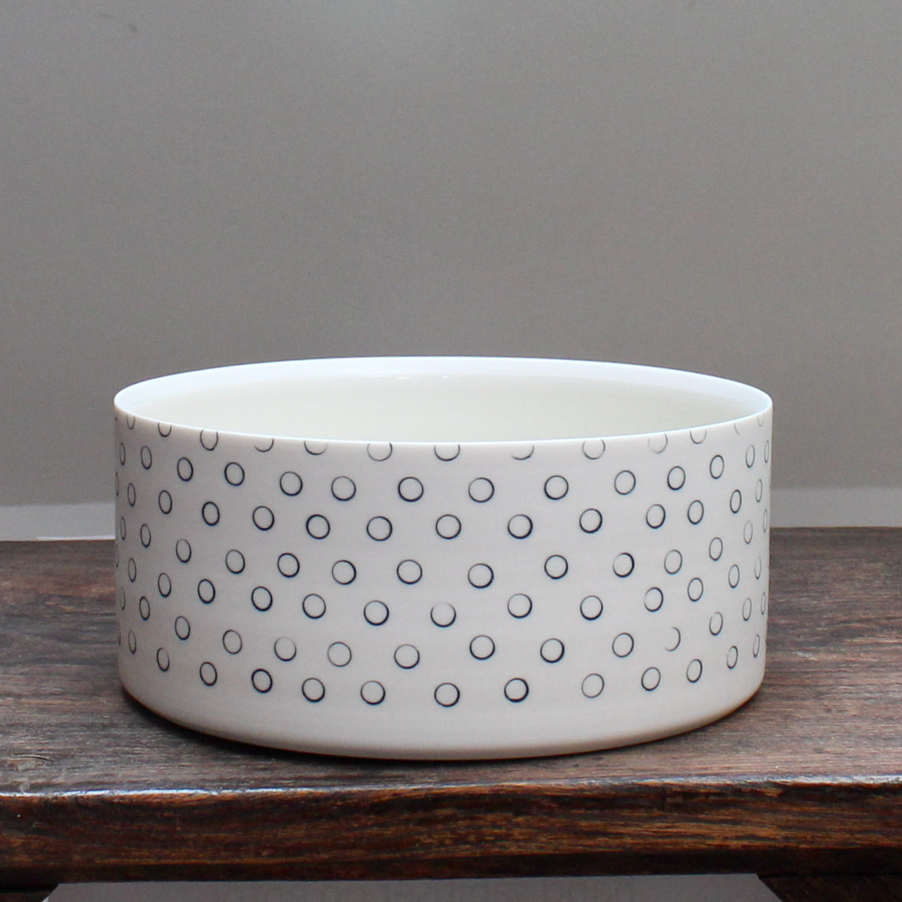 dish decorated with dark blue small circles sitting on a wooden table