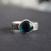 Blue tourmaline stone set in a textured silver ring