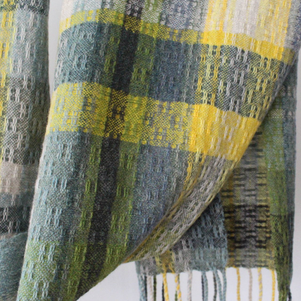 textile designer Teresa Dunne's hand-woven scarf in shades of blue, green and yellow