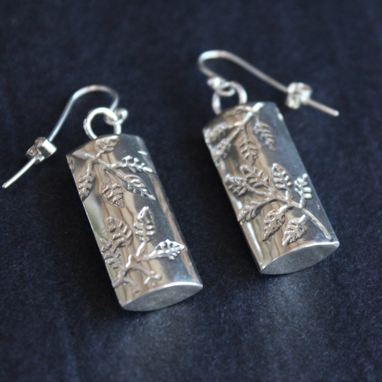 Plantae earrings with embossed ash leaves in silver by Beverly Bartlett