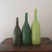 three ceramic bottles in different shades of green and incremental sizes by Lucy Burley ceramicist