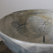 close up detail of large ceramic bowl glazed in pale greys and yellows made by UK ceramicist Kate Welton