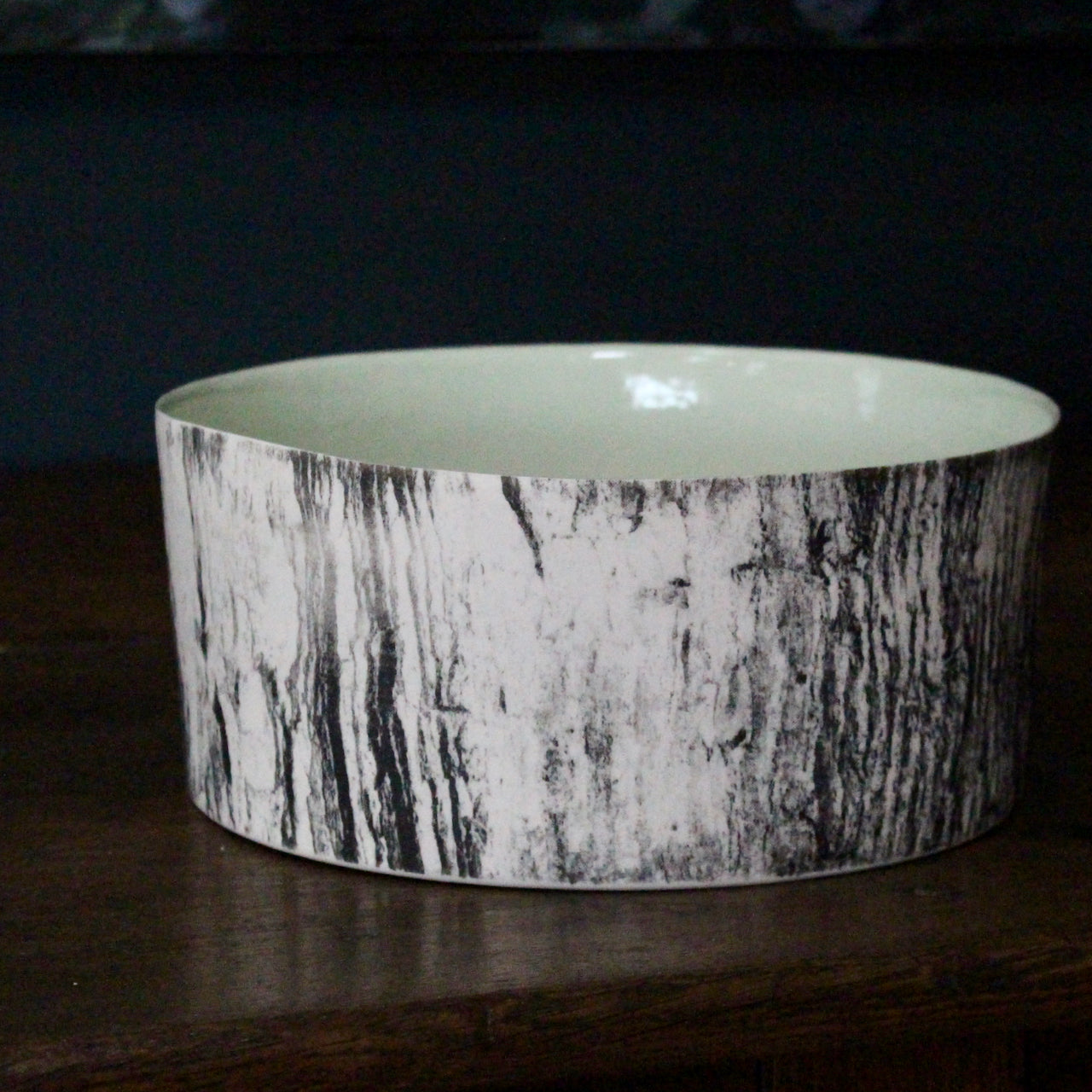 ceramic bowl with a green interior glaze and a black and white tree bark effect on exterior by UK ceramicist Heidi Harrington 