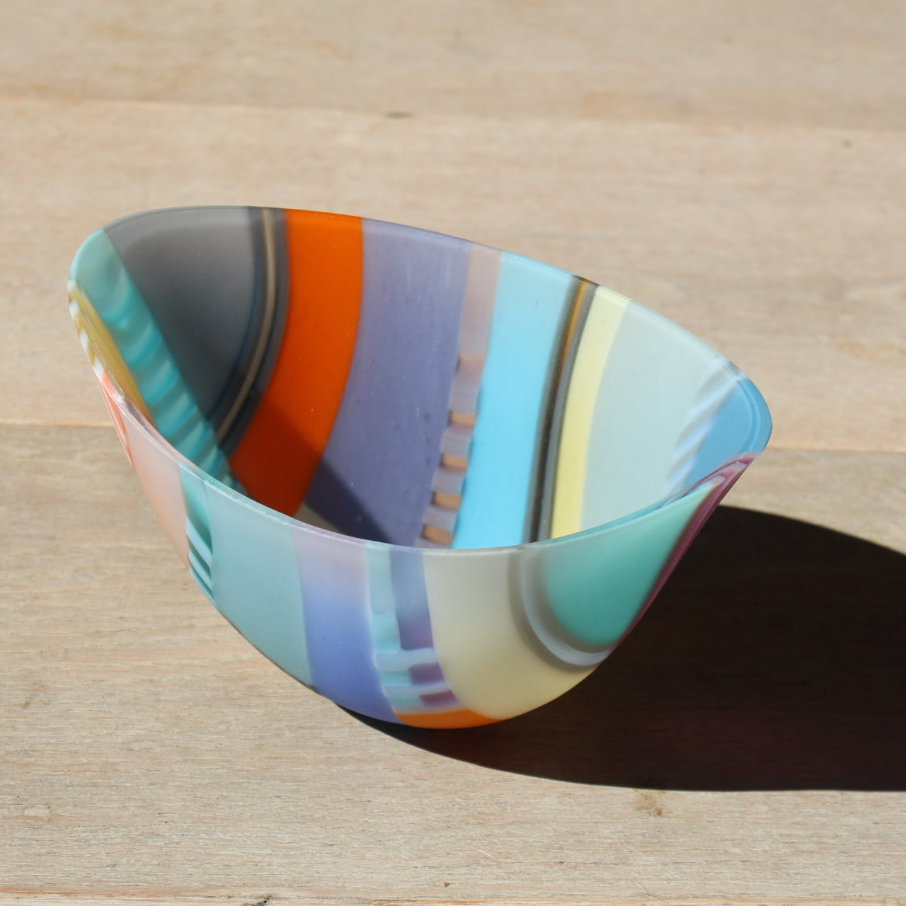 Beautiful oval shaped bowl by glass artist Ruth Shelley in tones of blue, orange, yellow and grey