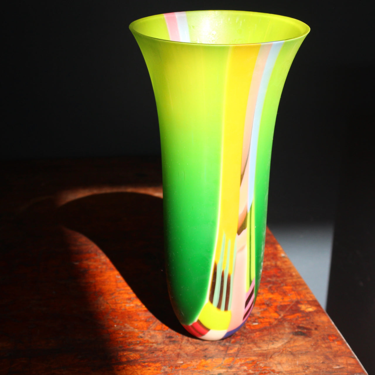 Tall vase in vibrant tone of green ,yellow, pink and blue by glass artist Ruth Shelley.