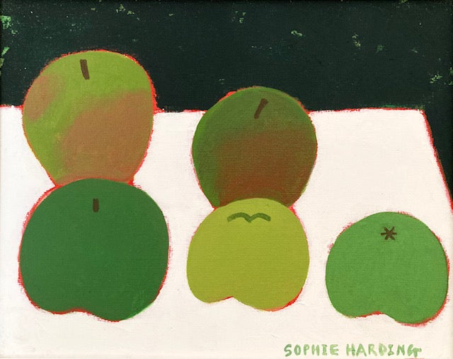 Five green apples placed on a white table with dark green background by Cornish artist Sophie Harding