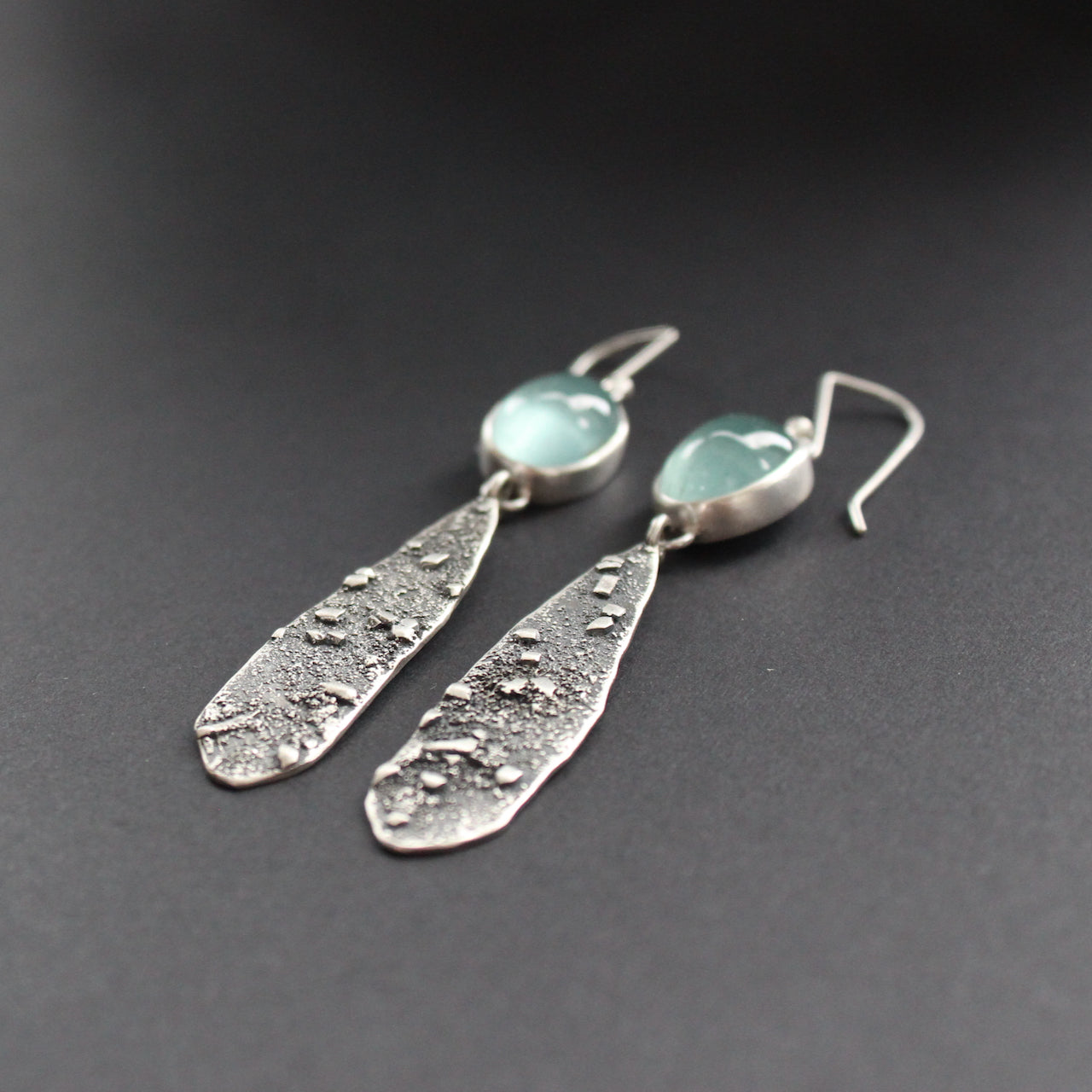 long lozenge shaped textured silver earrings with pale blue aquamarine stone setting by Carin Lindberg