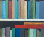 Two bookshelves containing varying coloured books by artist Philip Lyons