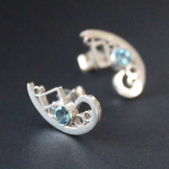 Silver curved design stud earrings set with topaz by UK artist Beverly Bartlett