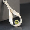 Drop curved hollow pendant set with peridot by artist UK Beverly Bartlett.