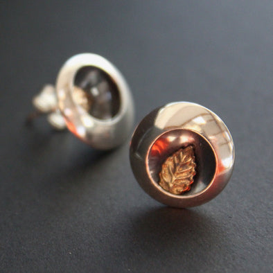Round silver stud earrings with leaf inlay by artist Beverly Bartlett