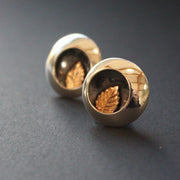 Round silver stud earrings with leaf inlay by UK artist Beverly Bartlett