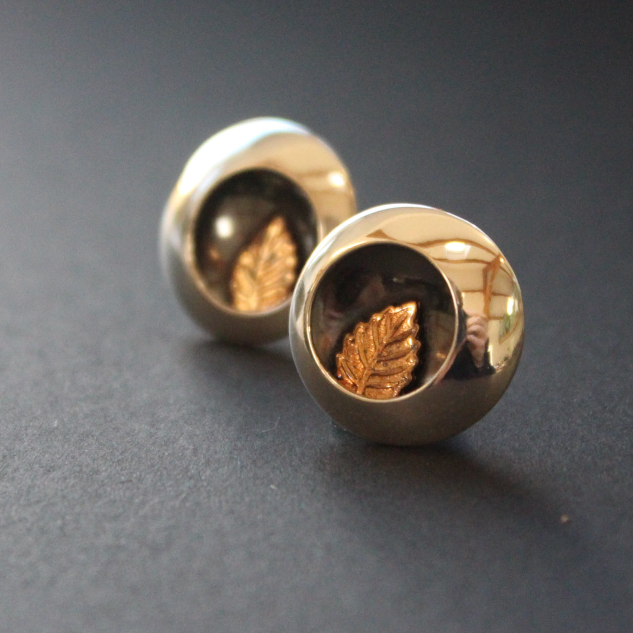 Round silver stud earrings with leaf inlay by UK artist Beverly Bartlett