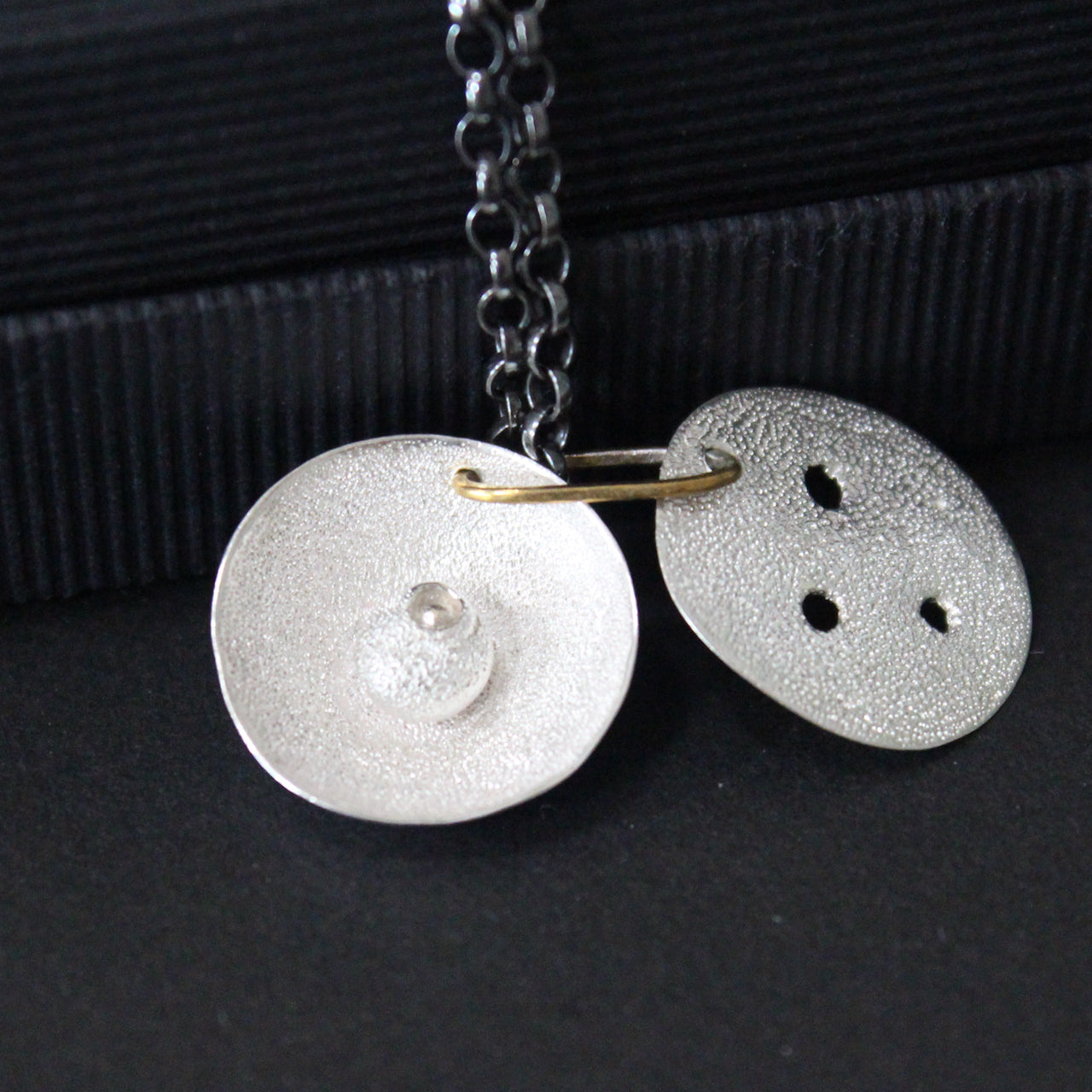 Organically created silver pendant, with delicate hand created surface, hand painted black patina chain and gold detailing by artist Claire Stockings-Baker