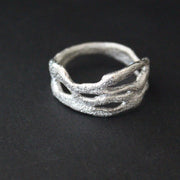 Organically hand sculpted silver Sea Siren ring, with delicate handcrafted surface detail by artist Claire Stockings-Baker