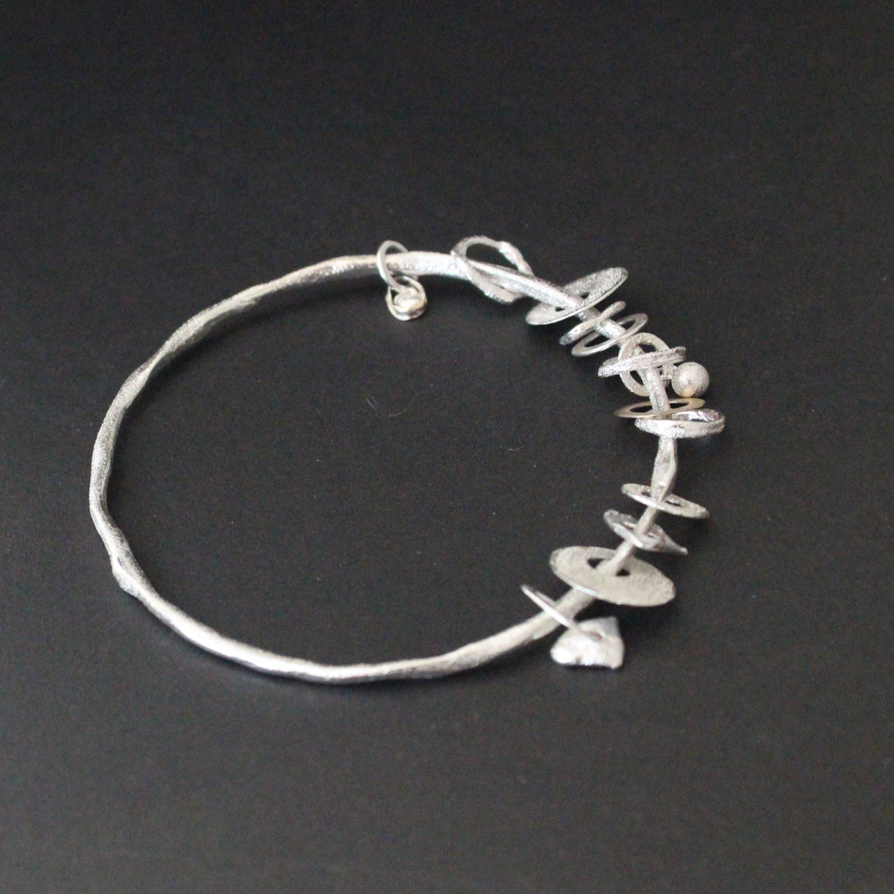 Organically hand sculpted Sea Siren bangle with individually created silver and gold pieces. Delicate hand crafted surface detail by Cornish artist Claire Stockings-Baker