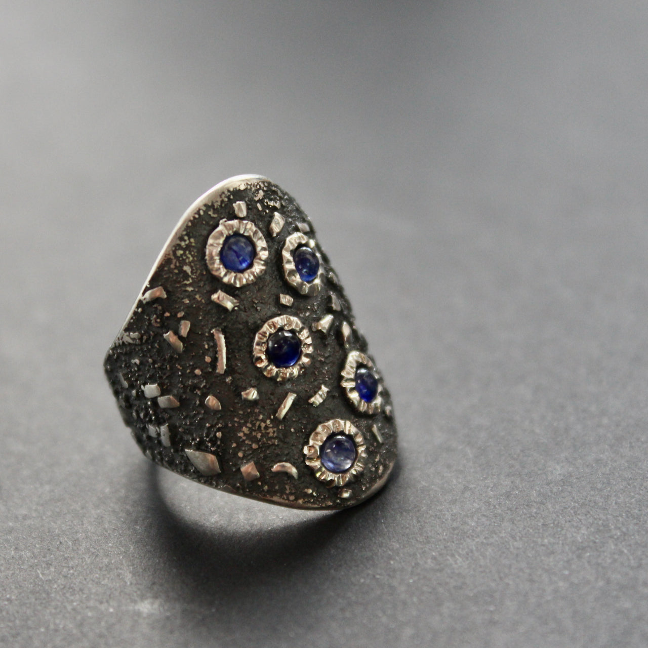 a large textured silver ring set with blue sapphires by Carin Lindberg, UK jeweller