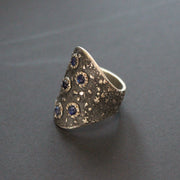 a Carin Lindberg large textured silver ring set with blue sapphires 