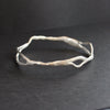 Organically shaped silver bangle by Cornish artist Claire Stockings Baker