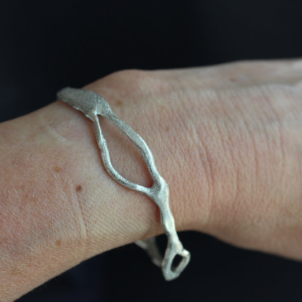 Organically shaped silver bangle by Cornish artist Claire Stockings Baker.