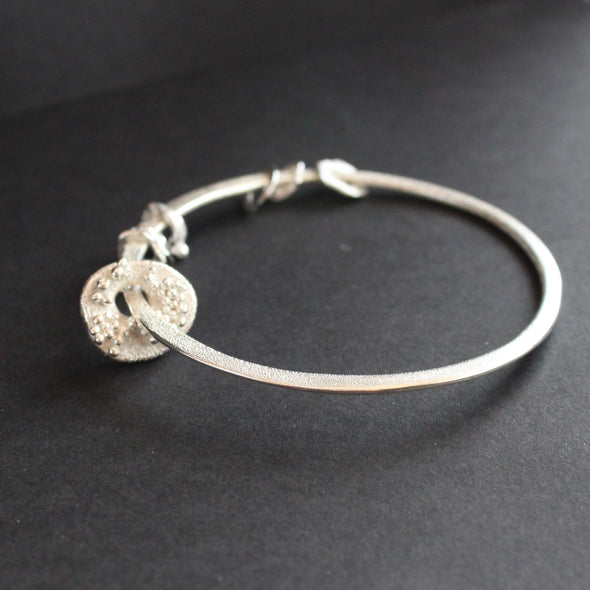 Silver bangle with silver discs of varying sizes on bangle by Cornwall artist Claire Stockings Baker