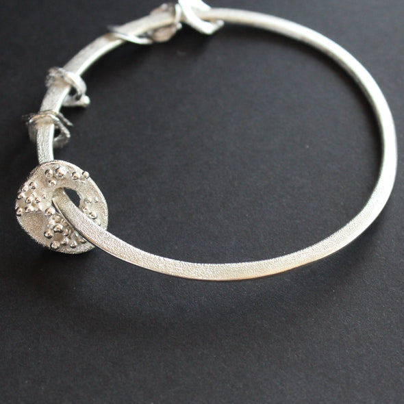 Silver bangle with silver discs of varying sizes on bangle by Cornwall artist Claire Stockings Baker.