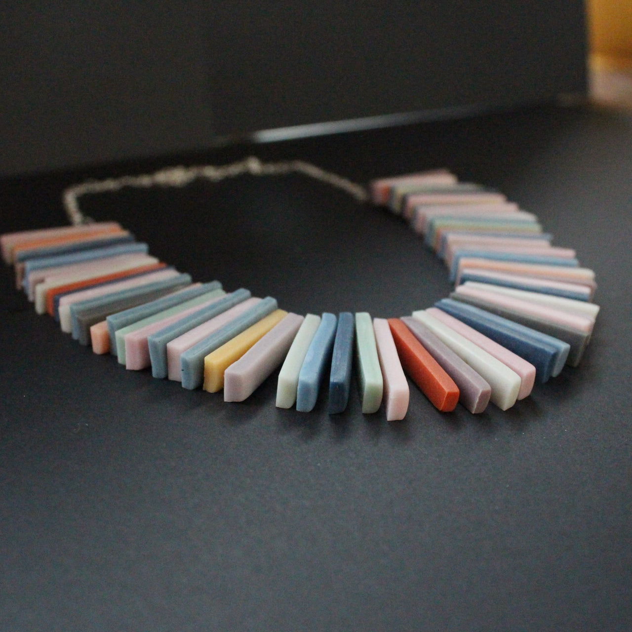 Polymer & resin clay rectangles in muted earth tones necklace by artist Clare Lloyd.