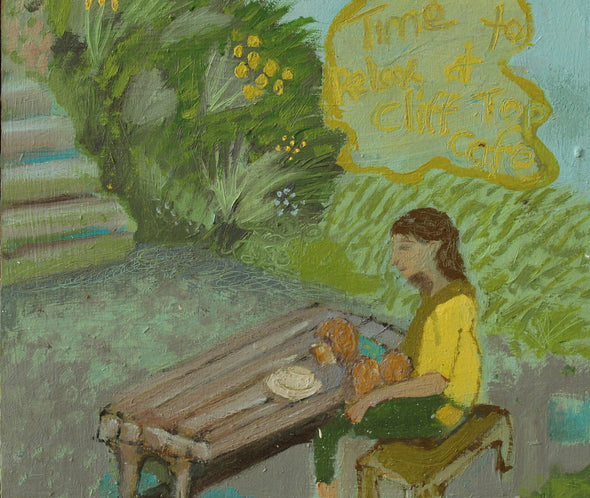 A person in a yellow  top with a dog on her lap sitting at a wooden table outside with greenery behind her and staircase leading off by Cornish artists Siobhan Purdy