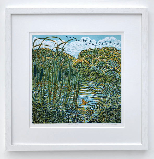 Lino print by Cornish artist Claire Armitage, foliage and bull rush in the foreground with water and trees and sky in background