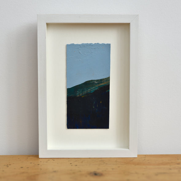 Dark hillside landscape with blue sky mixed media painting by UK artist Alice Robinson-Carter.