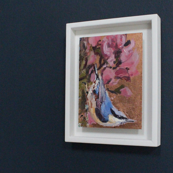 Jill Hudson painting of a nuthatch on a branch with pink flowers against a copper background.