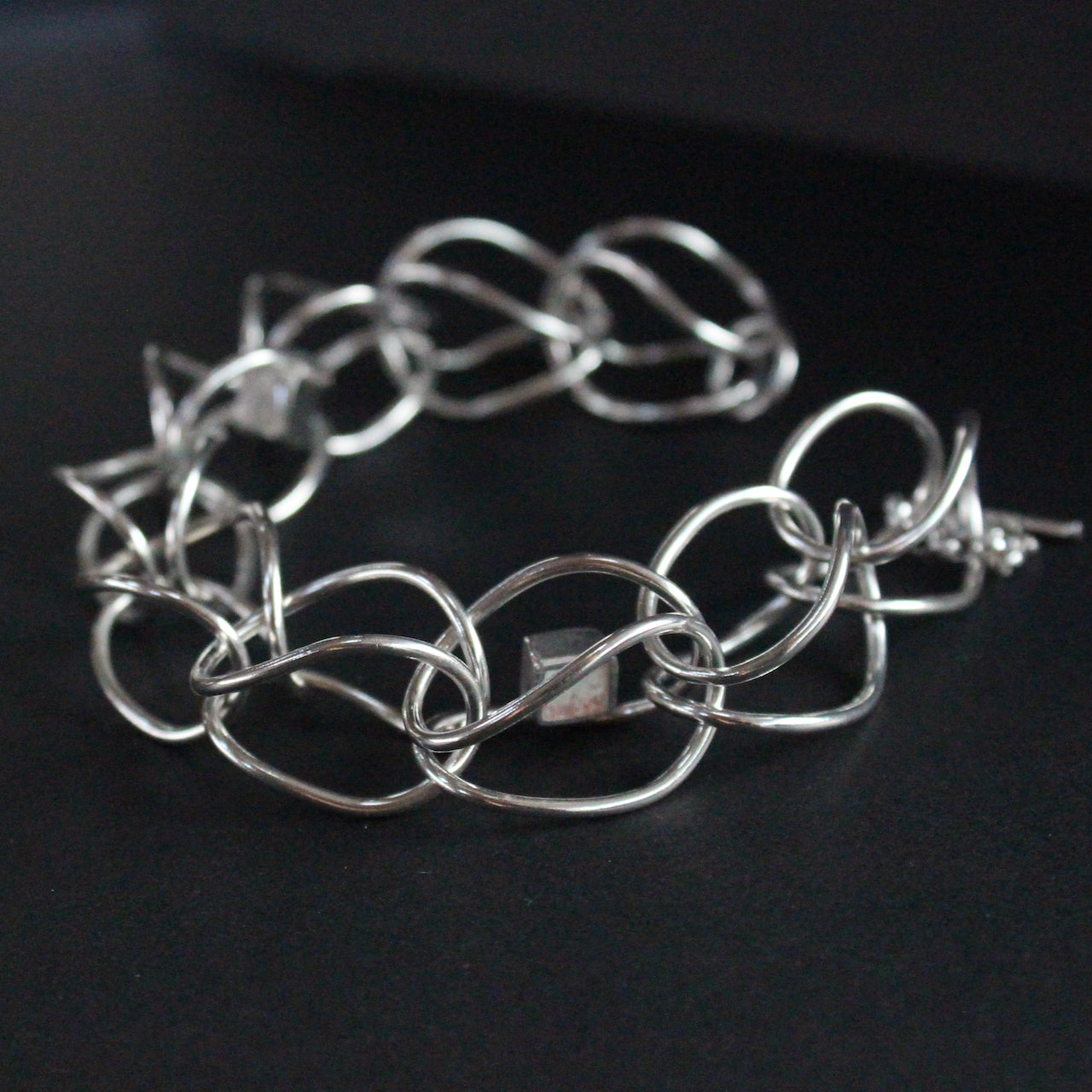 Sterling silver loop in loop chain bracelet by artist Amy Stringer.