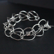 Sterling silver loop in loop chain bracelet by artist Amy Stringer.