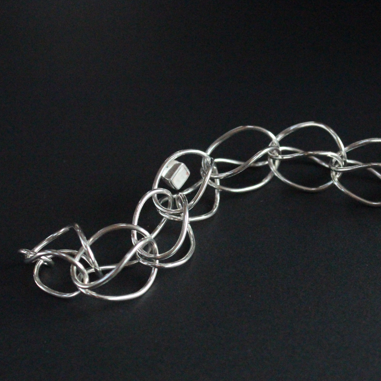 Sterling silver loop in loop chain bracelet by UK artist Amy Stringer