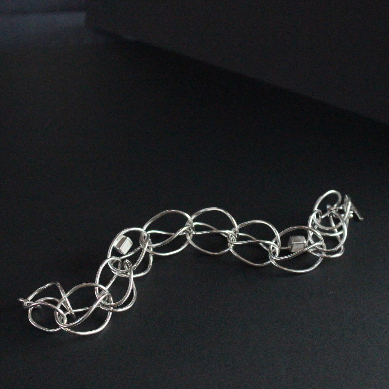 Sterling silver loop in loop chain bracelet by UK artist Amy Stringer.