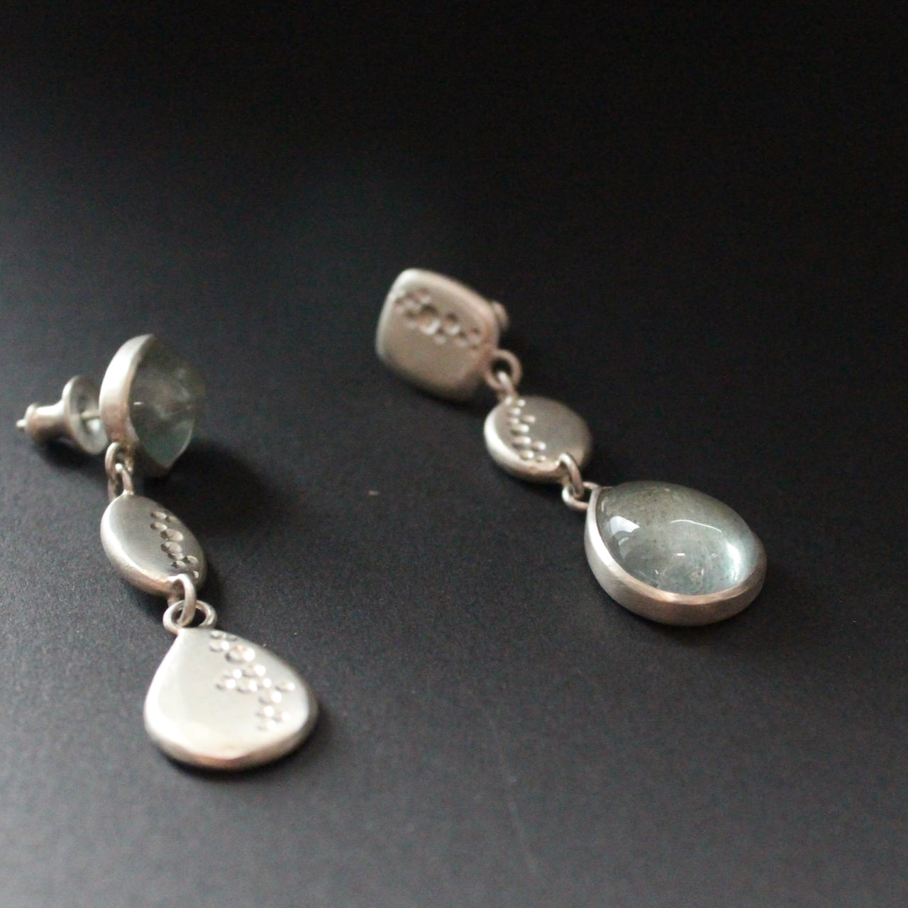 a pair of Carin Lindberg earrings of pale blue stones in silver drop setting
