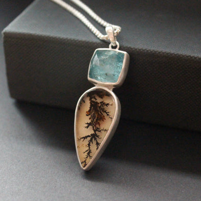 silver pendant by Carin Lindberg with teardrop shaped agate and blue stone set above it