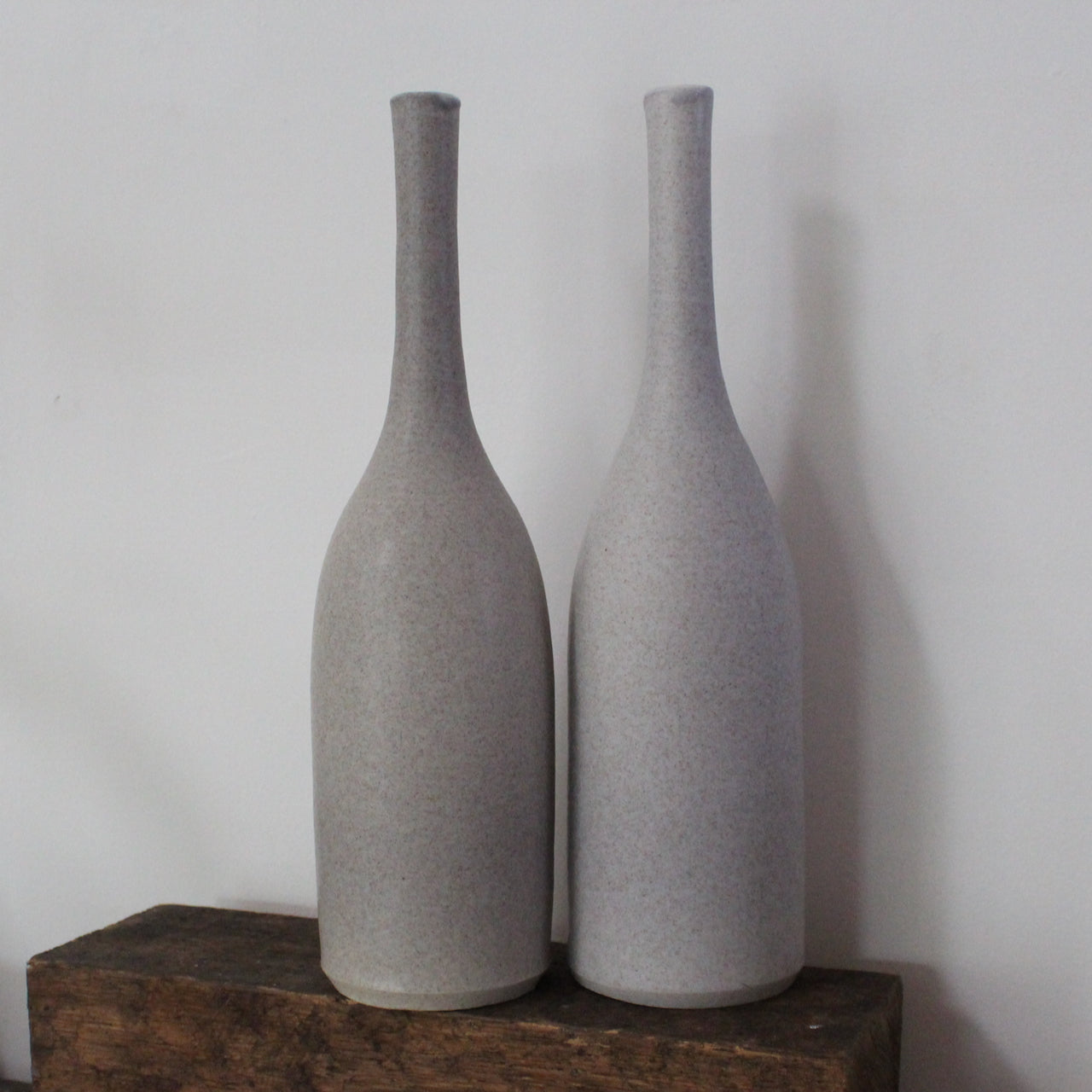 a pair of grey ceramic bottles by UK ceramicist Lucy Burley. 
