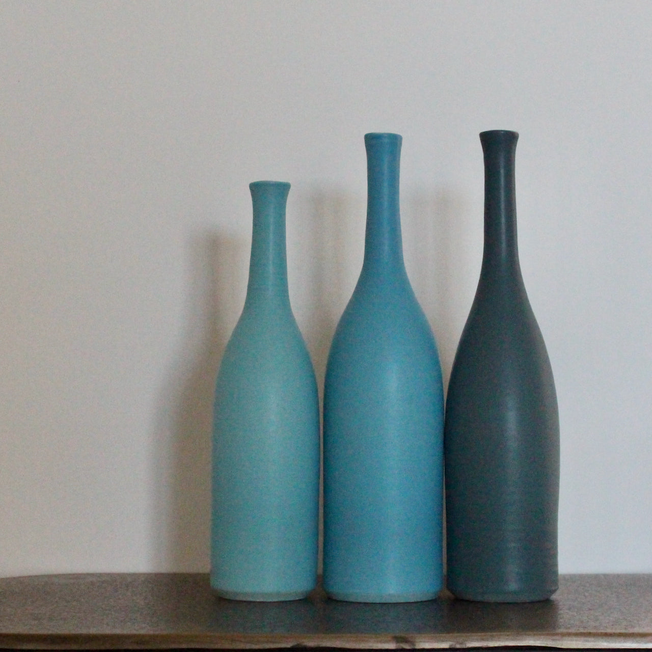 trio of blue ceramic bottles by UK potter Lucy Burley 